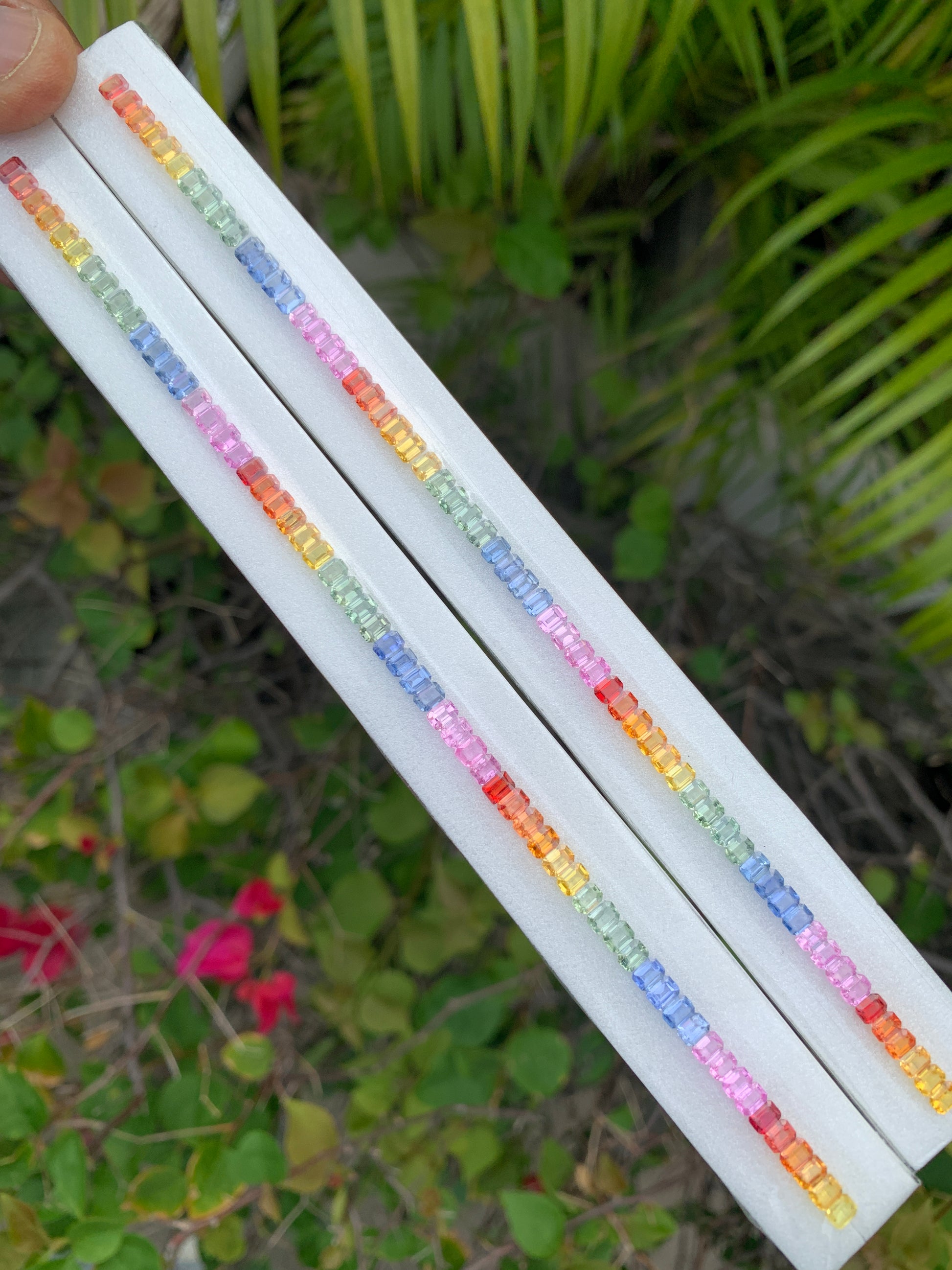 Heated African rainbow sapphire calibrated 4x3mm emerald cut single line strand