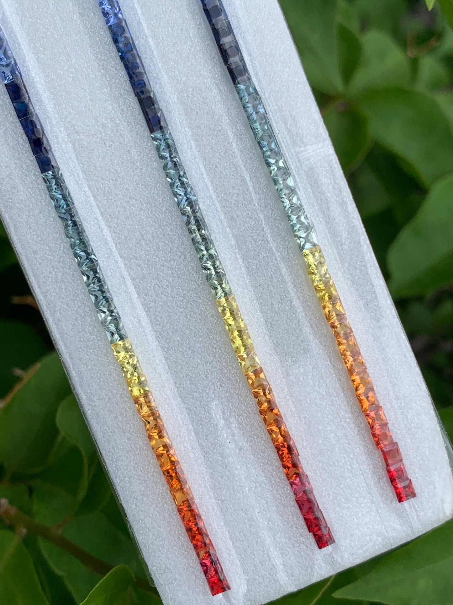 Heated African rainbow sapphire calibrated 2.7mm square princess cut 46 pieces
