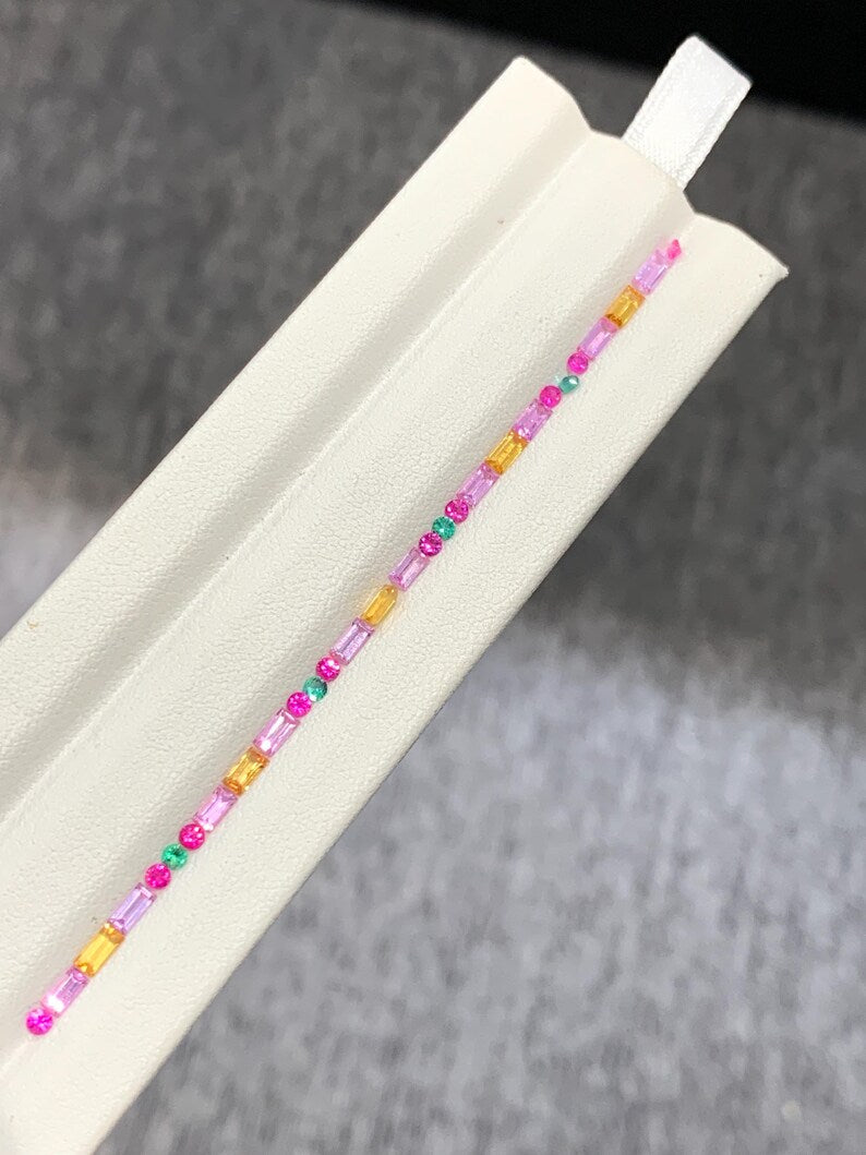 Close up matched Fancy Sapphire Ruby Emerald baguette gemstones for custom jewelry